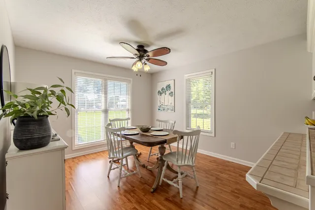 a view of a dining room with furniture window and wooden floor