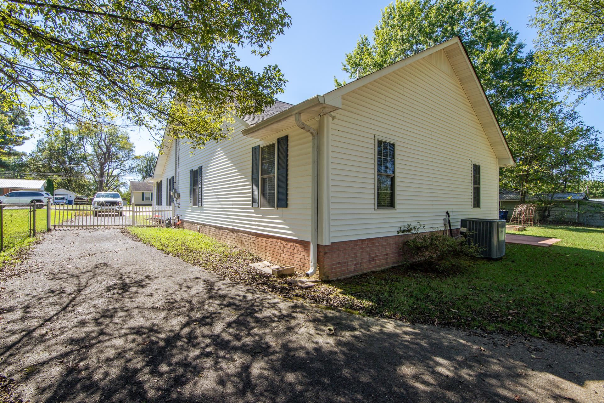 224 Willow Drive Adamsville, TN 38310 - Photo 19 of 40 a view of a house with backyard and sitting area