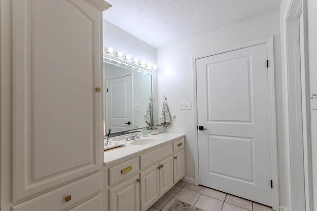 a bathroom with a double vanity sink and mirror