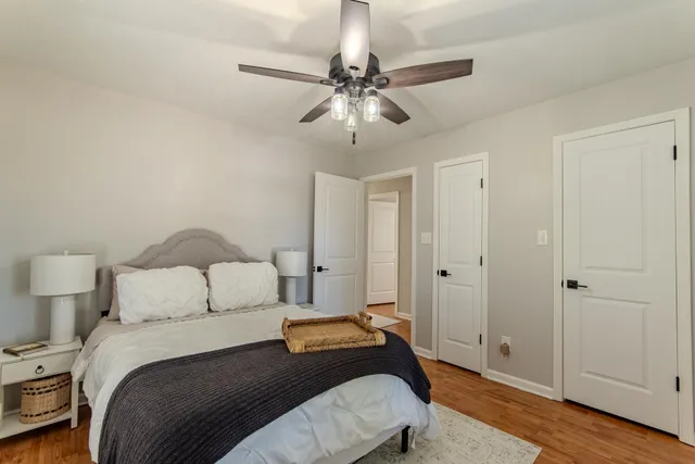 a bedroom with a bed and a chandelier