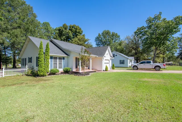 a front view of a house with garden