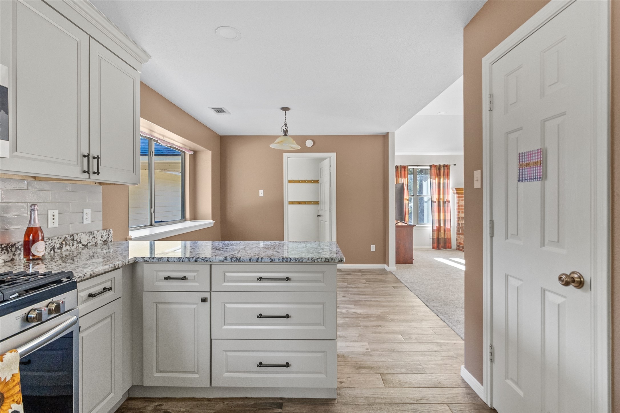11270 Summit Drive Conroe, TX 77303 - Photo 12 of 35 a kitchen with granite countertop white cabinets and stainless steel appliances