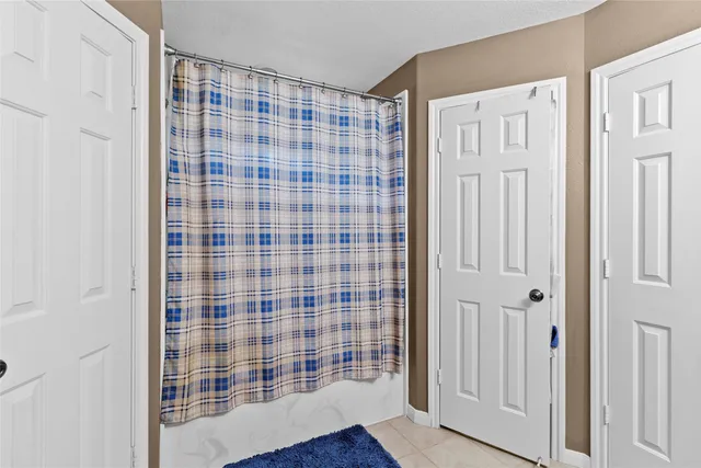 a view of empty room with wooden floor and cabinet
