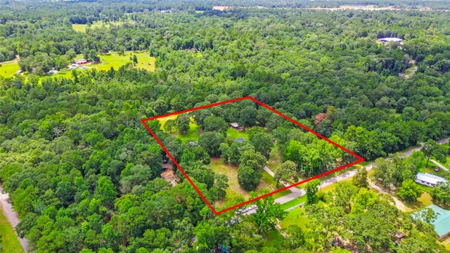 a backyard of a house with lots of green space and garden