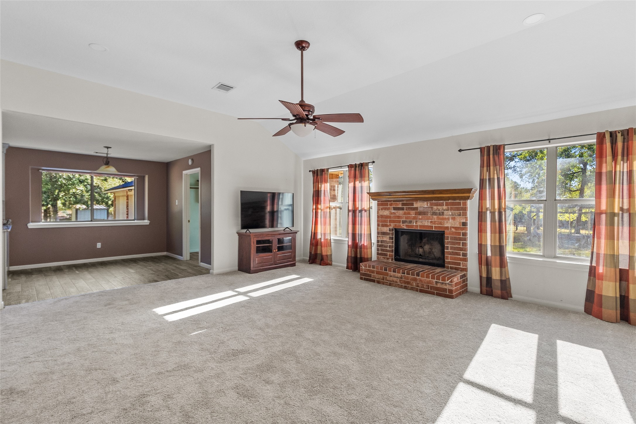 11270 Summit Drive Conroe, TX 77303 - Photo 6 of 35 a living room with furniture a fireplace and a flat screen tv