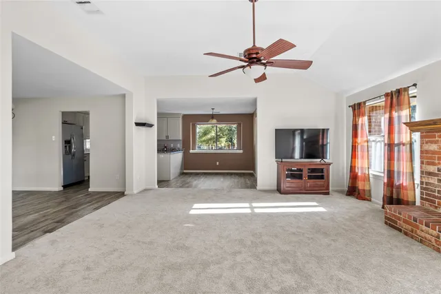 a view of a livingroom with a flat screen tv and a window