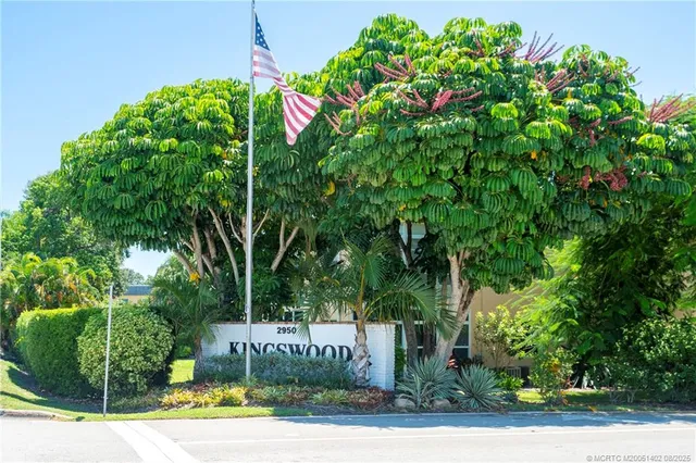 a view of a hallway with a glass door and shower