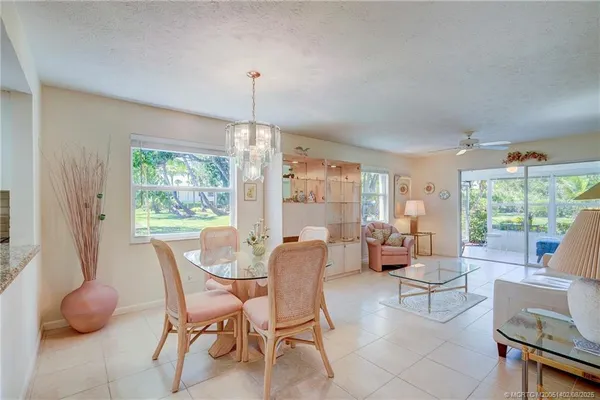 a view of a dining room with furniture wooden floor and chandelier