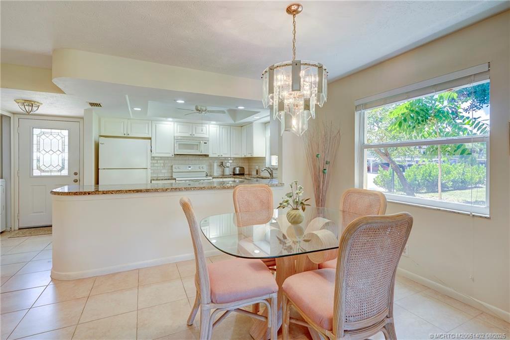 2950 Southeast Ocean Boulevard, Unit 1211 Stuart, FL 34996 - Photo 22 of 61 a view of a dining room with furniture window and outside view