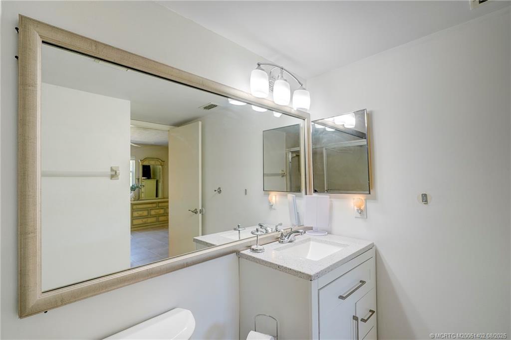 2950 Southeast Ocean Boulevard, Unit 1211 Stuart, FL 34996 - Photo 33 of 61 a bathroom with a sink and a mirror