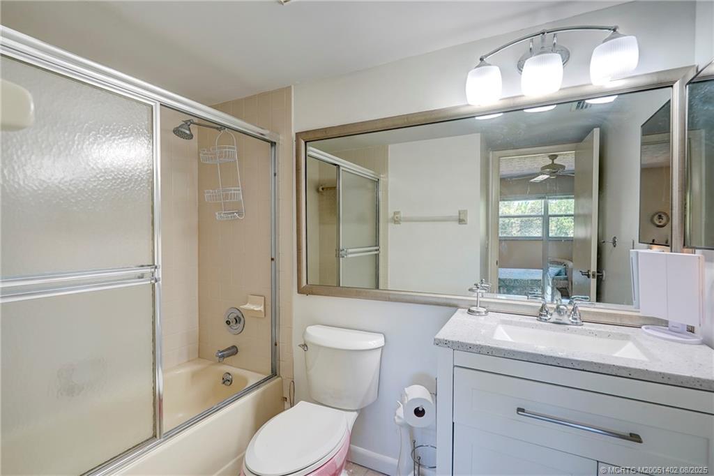 2950 Southeast Ocean Boulevard, Unit 1211 Stuart, FL 34996 - Photo 34 of 61 a bathroom with a toilet a sink and glass door