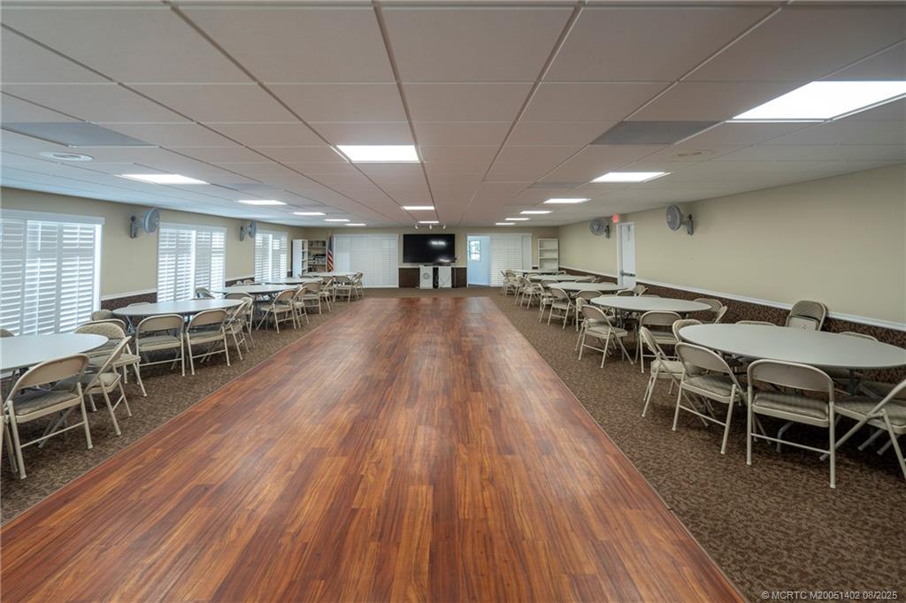 2950 Southeast Ocean Boulevard, Unit 1211 Stuart, FL 34996 - Photo 41 of 61 a view of a dining room with furniture wooden floor and chandelier