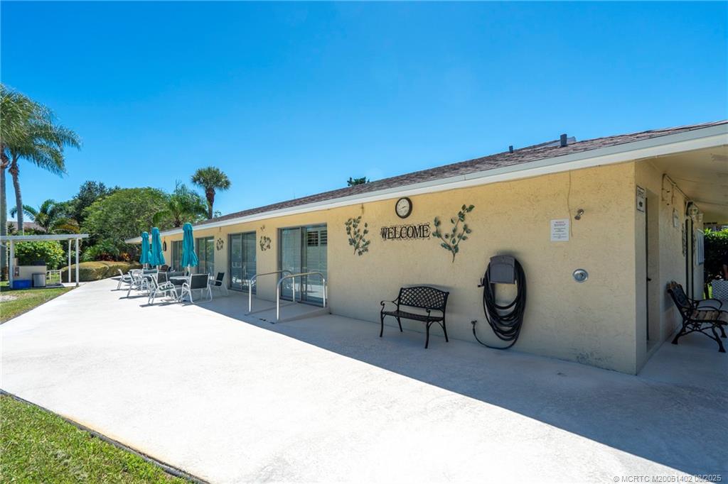 2950 Southeast Ocean Boulevard, Unit 1211 Stuart, FL 34996 - Photo 47 of 61 a view of a patio with table and chairs and potted plants