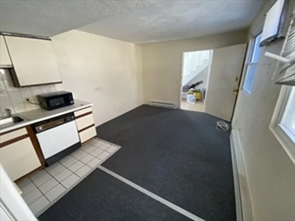 a kitchen with stainless steel appliances a stove a microwave and a refrigerator