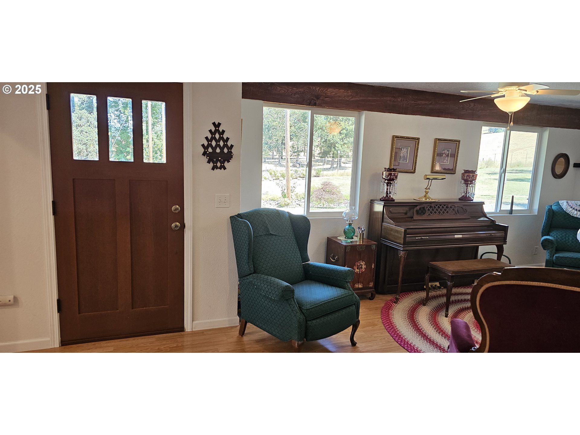 524 Azalea Drive Elkton, OR 97436 - Photo 18 of 48 a living room with furniture a flat screen tv and large windows