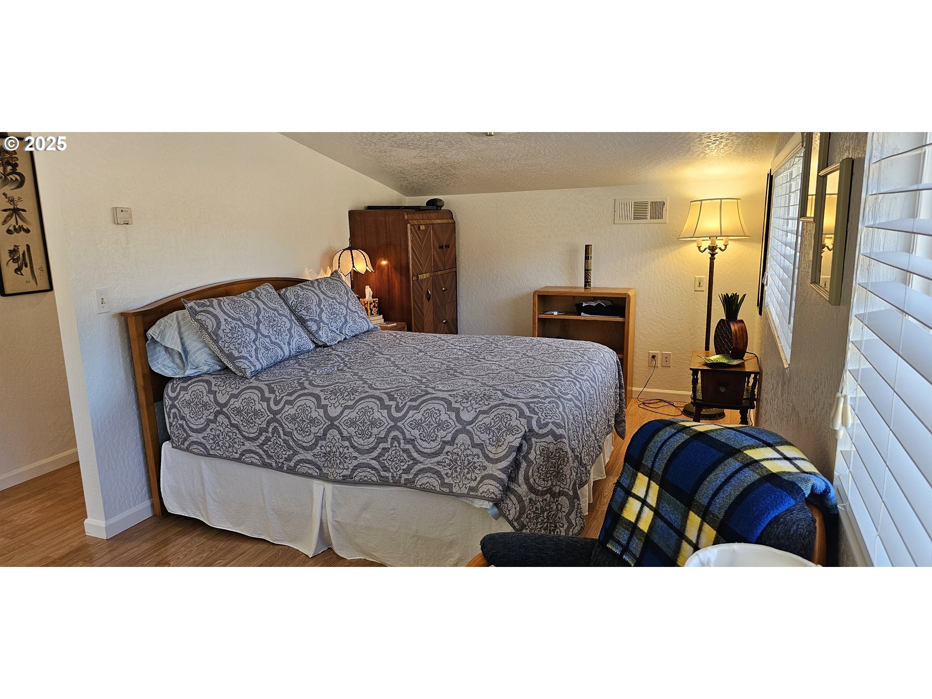 524 Azalea Drive Elkton, OR 97436 - Photo 42 of 48 a bedroom with a bed and wooden floor