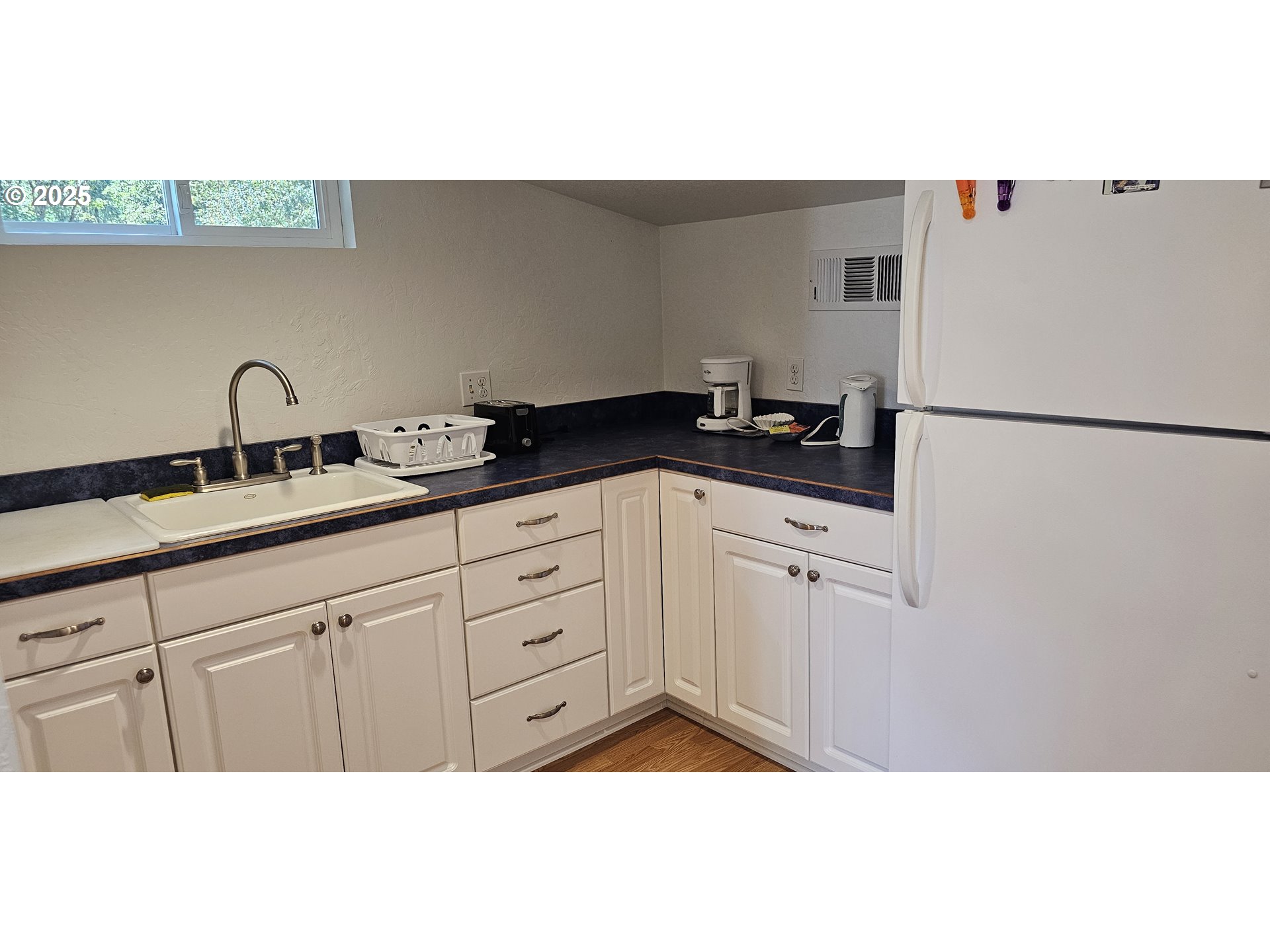 524 Azalea Drive Elkton, OR 97436 - Photo 43 of 48 a kitchen with granite countertop a sink a stove a refrigerator and cabinets