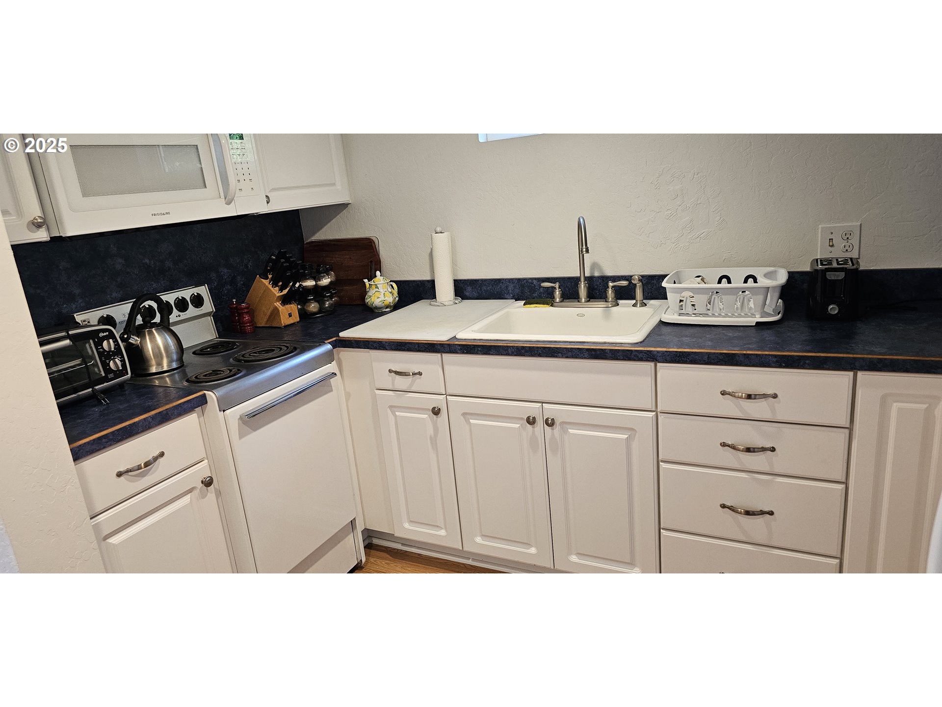 524 Azalea Drive Elkton, OR 97436 - Photo 44 of 48 a kitchen with white cabinets