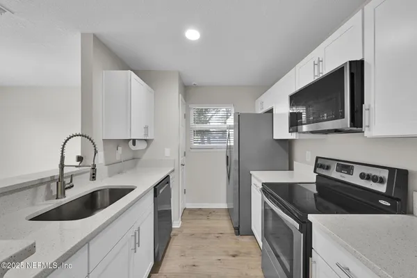 a kitchen that has a sink and a stove