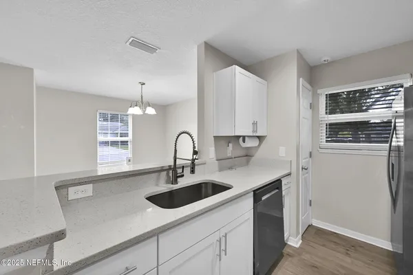 a kitchen with stainless steel appliances a sink and a refrigerator