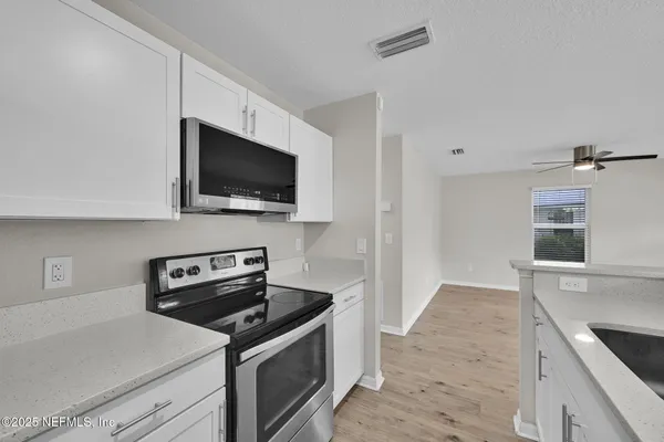 a kitchen with a stove and a microwave