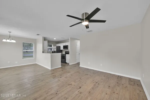 a view of a kitchen with a sink and cabinet with wooden floor