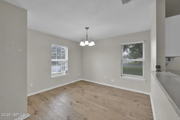 a view of an empty room with a window
