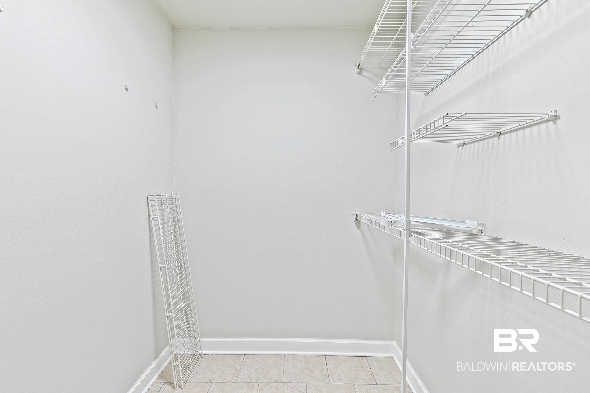 110 5th Street, Unit C103 Daphne, AL 36526 - Photo 35 of 46 Walk in closet featuring light tile patterned floors