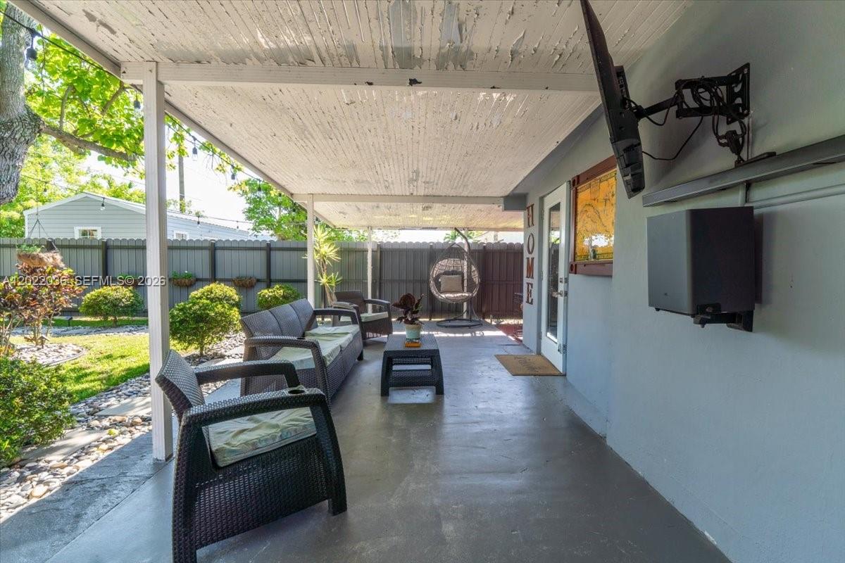 120 West 50th Street Hialeah, FL 33012 - Photo 17 of 22 a living room with patio furniture and garden view