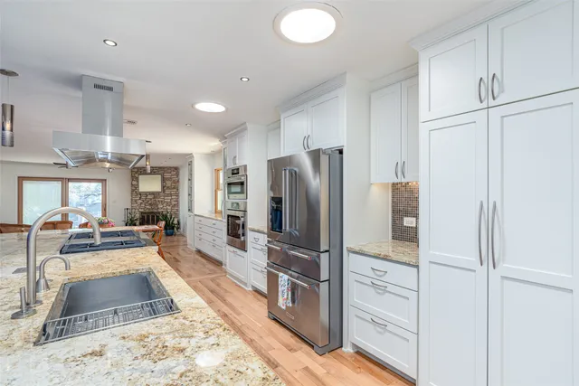 a view of a chairs and table in a back yard of the house