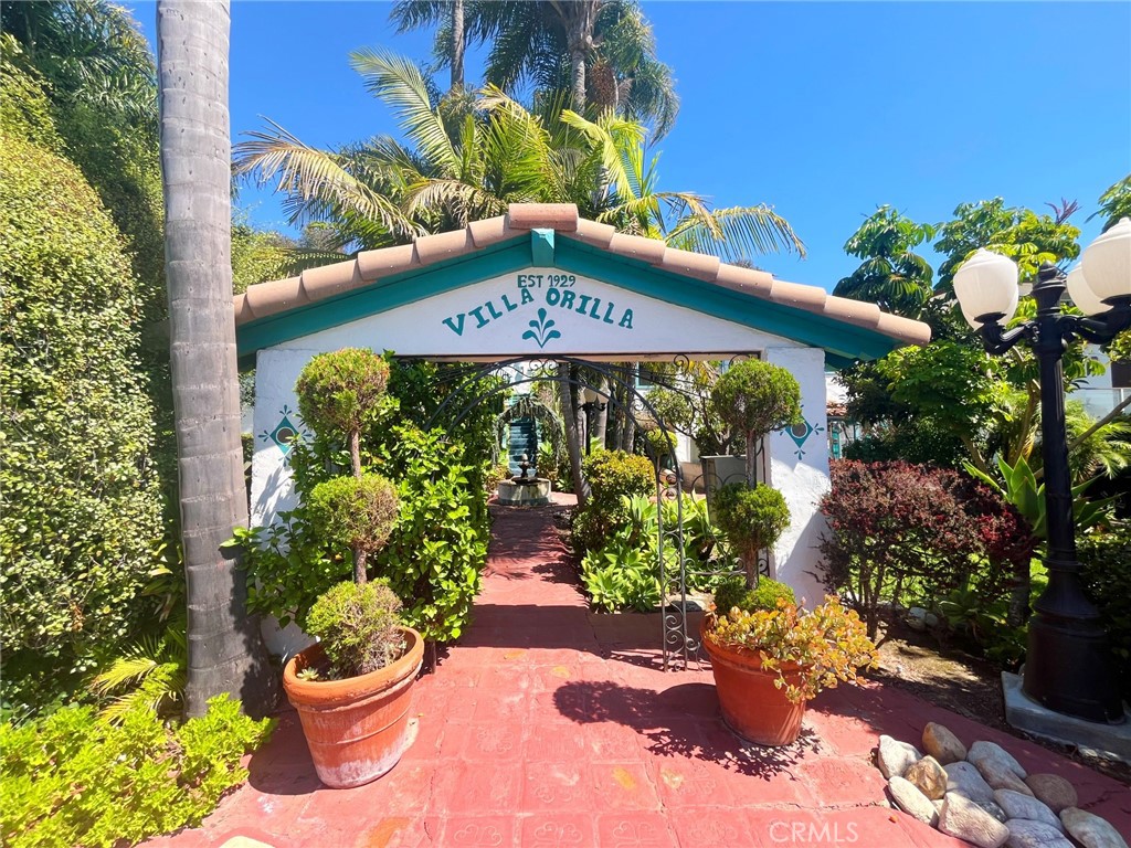 a front view of a multi story building with a lot of flower plants