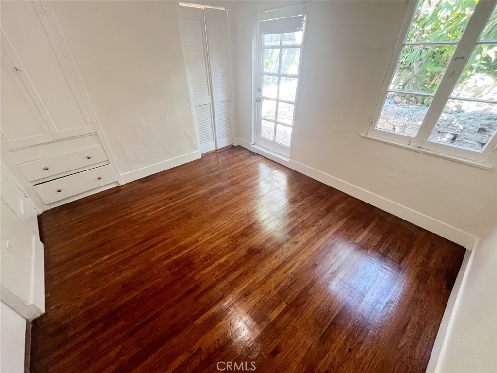 33910 Orilla Road, Unit 7 Dana Point, CA 92629 - Photo 17 of 50 a view of an empty room with wooden floor and a window