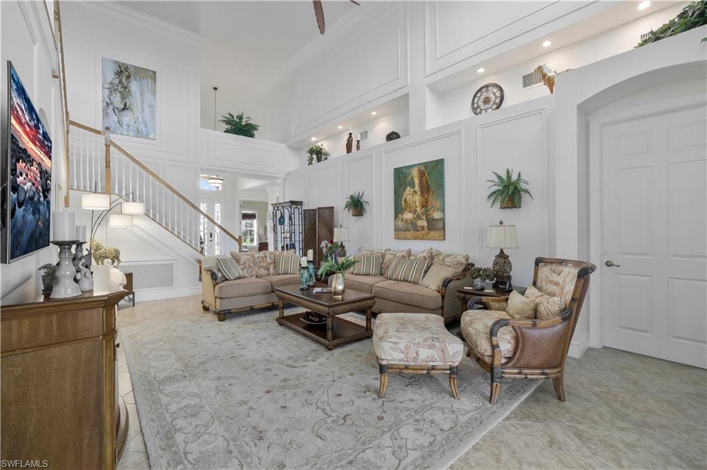 9104 Quartz Lane Naples, FL 34120 - Photo 15 of 47 a living room with furniture and a flat screen tv
