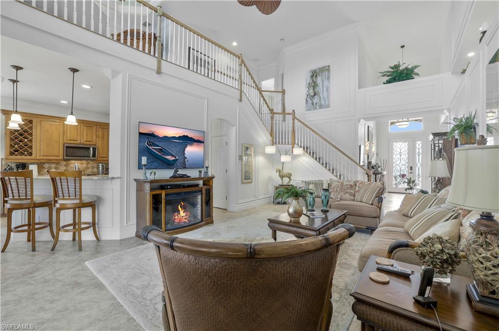9104 Quartz Lane Naples, FL 34120 - Photo 16 of 47 a living room with furniture and a fireplace