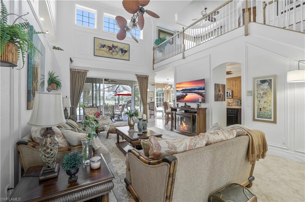 9104 Quartz Lane Naples, FL 34120 - Photo 17 of 47 a living room with fireplace furniture and a flat screen tv