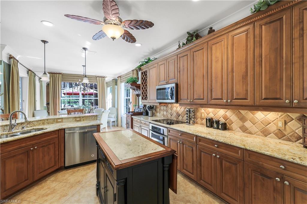 9104 Quartz Lane Naples, FL 34120 - Photo 21 of 47 a kitchen with a sink stove and cabinets
