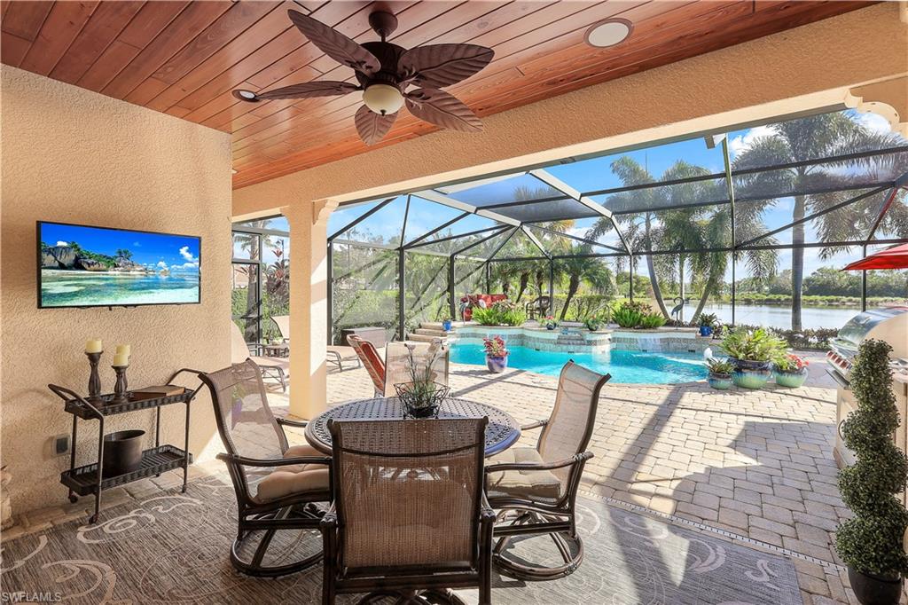 9104 Quartz Lane Naples, FL 34120 - Photo 6 of 47 a dining room with furniture and a floor to ceiling window