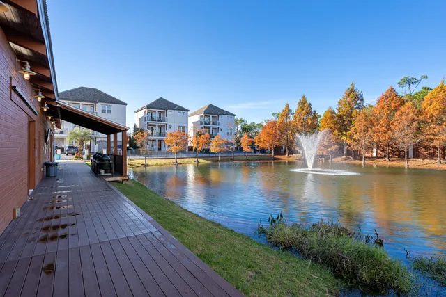 a living room with furniture and large windows