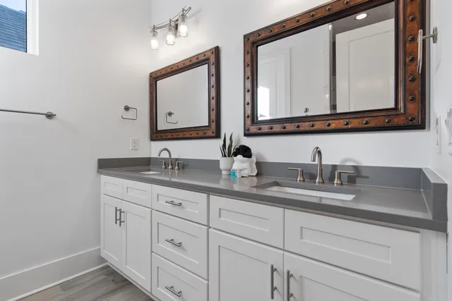 a bedroom with a bed a chandelier and a window