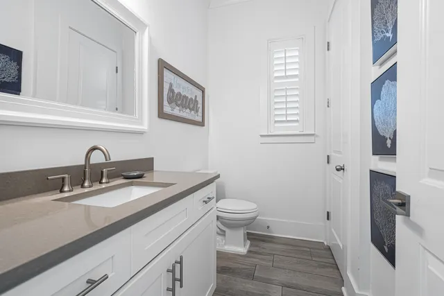 a bedroom with two beds and wooden floor