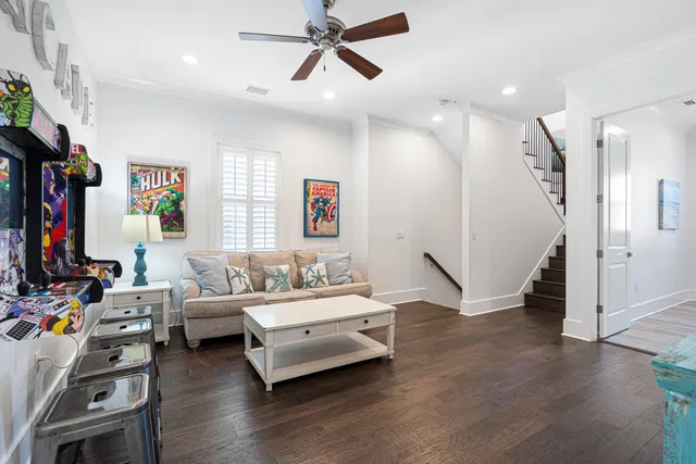 a living room with furniture a chandelier and a flat screen tv