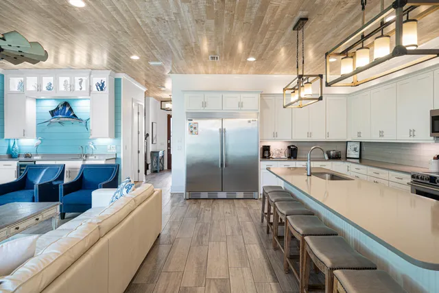 a kitchen with stainless steel appliances a sink a stove and a wooden floors