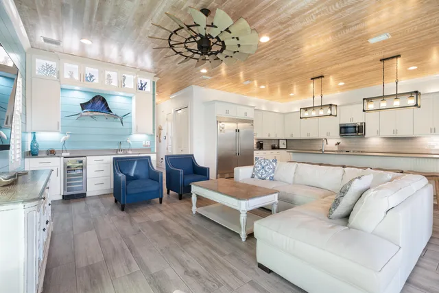 a kitchen with stainless steel appliances granite countertop a refrigerator and white cabinets