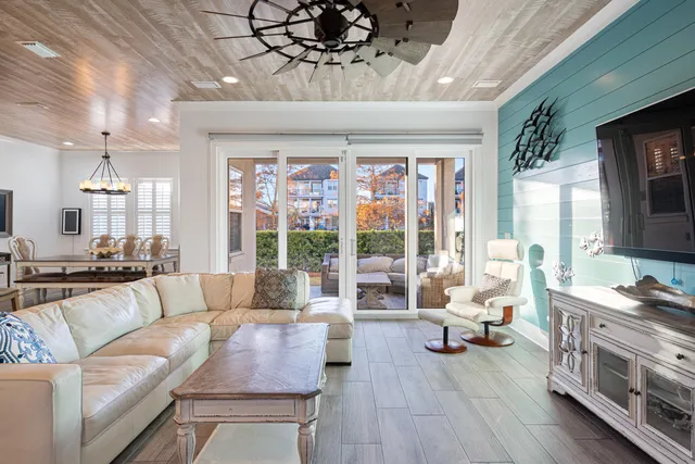 a view of a livingroom with wooden floor and a fireplace