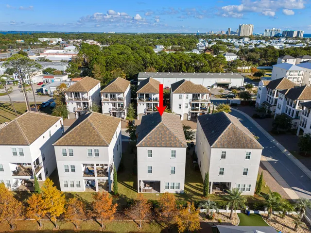 a view of a swimming pool with a table and chairs under an umbrella