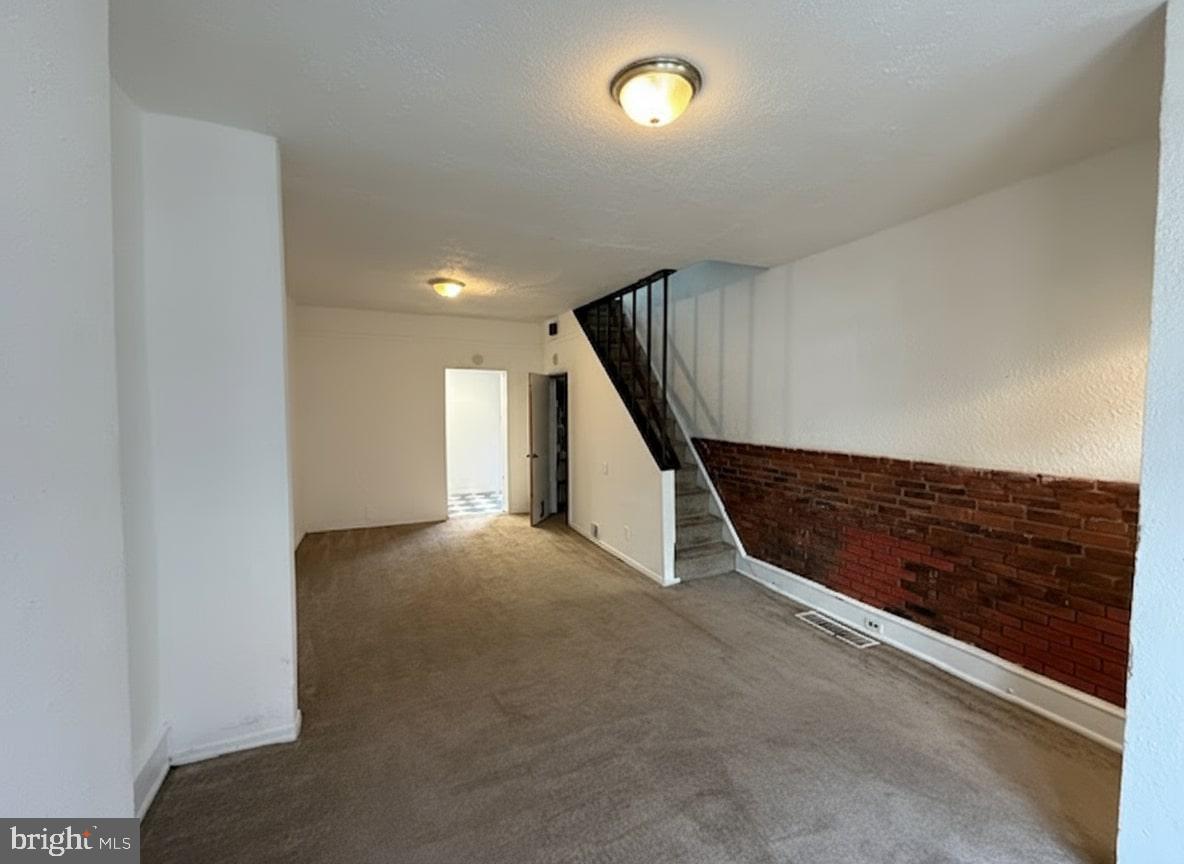 a view of an empty room with stairs