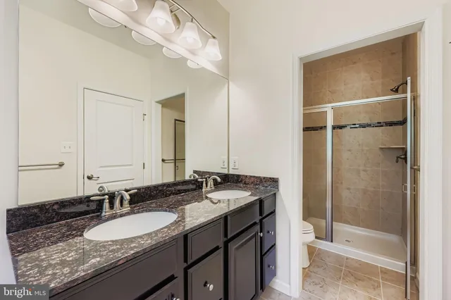 a bathroom with a granite countertop sink mirror and double