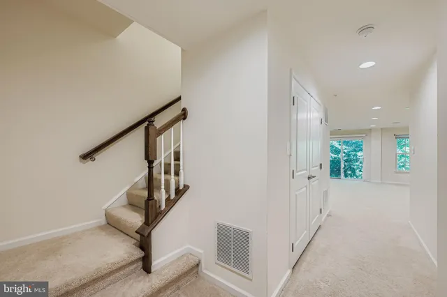 a view of entryway with wooden floor and stairs