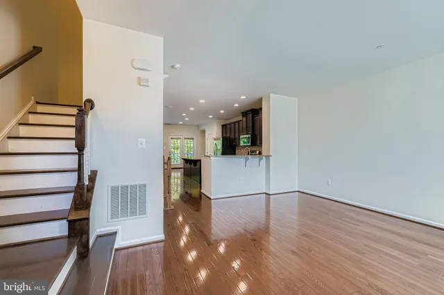 a view of a kitchen with wooden floor and electronic appliances