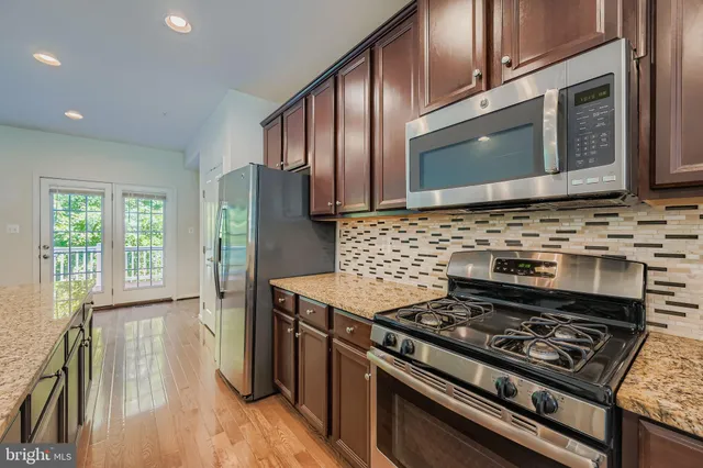 a stove top oven sitting inside of a kitchen